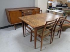 A six piece mid 20th century teak dining room suite comprising of double door sideboard with four