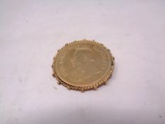 A gilded silver coin brooch
