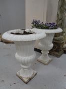 A pair of Victorian style cast iron garden urns