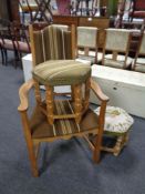 A continental blonde oak armchair together with two further blonde oak hexagonal footstools
