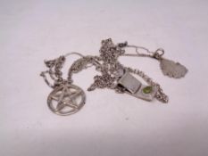 Four silver pendants on chains