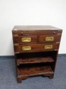 A campaign style bookcase fitted three drawers above with slide