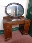 An Edwardian oval oak framed bevel edged mirror together with a walnut dressing table (no mirror)