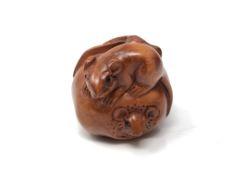 A carved Chinese hardwood netsuke - Two rats on fruit