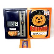 A Swatch Halloween Pumpkin watch in box.