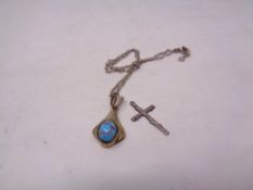 A silver pendant on chain