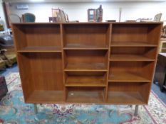 A set of 20th century teak Duba Furniture open bookshelves on raised metal legs