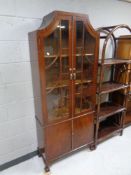 An Art Deco double door glazed bookcase fitted cupboards beneath