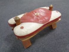 A camel stool with leather saddle