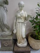 A composite garden statue of a maiden on a concrete base