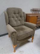 A button back wingback armchair