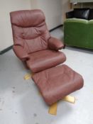 A late 20th century Scandinavian swivel armchair with stool