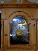 A continental stripped pine longcase clock with brass dial,