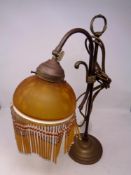 A brass Art Deco style table lamp with glass beaded shade