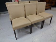 A set of six function room chairs upholstered in a beige vinyl