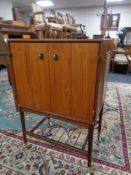 A mid 20th century teak Phillips television cabinet on casters