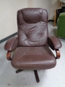 A late 20th century beech framed Scandinavian brown leather swivel armchair