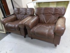 A pair of mid 20th century Scandinavian brown button back leather armchairs