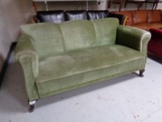 An Edwardian settee upholstered in a green dralon