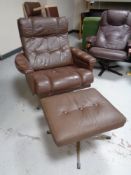 A 20th century Scandinavian brown button leather swivel armchair and stool on metal base