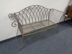 A wrought iron garden bench