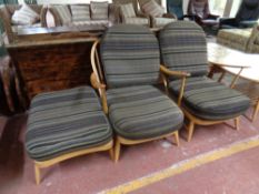 A pair of Ercol solid elm and beech armchairs with matching footstool (as found)
