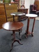 A marble topped plant stand together with two wine tables on tripod bases