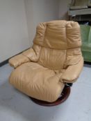 An Ekornes stressless leather armchair with matching footstool (camel)