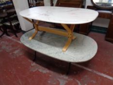 Two oval composite coffee tables on pedestal bases