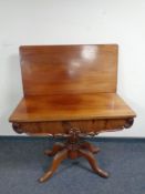 A 19th century mahogany turnover top tea table on tripod base
