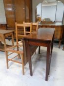 An antique mahogany drop leaf table together with two Edwardian bedroom chairs (as found)