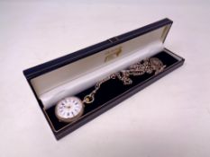 A silver fob watch on Albert chain