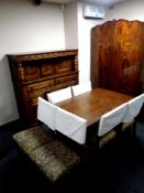A carved oak refectory extending dining table and bulbous legs and a set of six tapestry