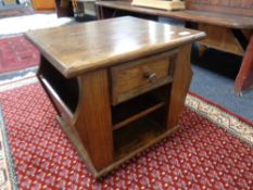 A magazine lamp table fitted a drawer in an oak finish