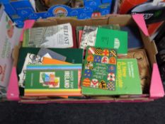 A box of 20th century books and folded maps