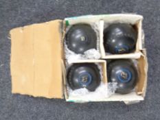 A set of four Thomas Taylor lawn bowls,