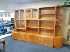 A 20th century teak G Plan display shelving unit fitted cupboards below,
