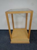 A square oak shop display stand with one glass shelf