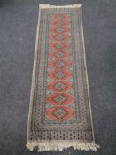A fringed Bokhara design runner,