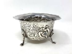 A silver sugar bowl with embossed panels depicting animals, Birmingham 1976,