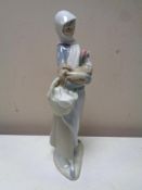 A Lladro figure : Girl with bird