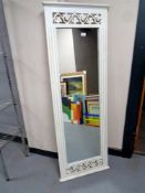 A contemporary white framed hall mirror