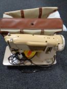 A Singer electric sewing machine in carry bag