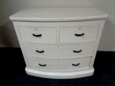 An antique painted pine bow-fronted four drawer chest