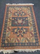 A machine made fringed rug of geometric design