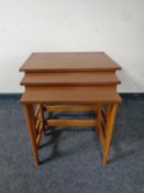 A nest of three 20th century teak tables