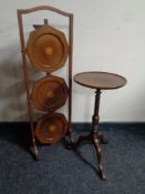 A late 19th century inlaid mahogany three tier folding cake stand together with a wine table