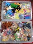 Two plastic storage crates with lids containing a very large quantity of sealed McDonald's Happy