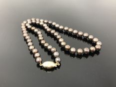 A strap of pearls on 18ct gold clasp