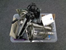 A crate of three mirrored panels, camera tripod, binoculars,